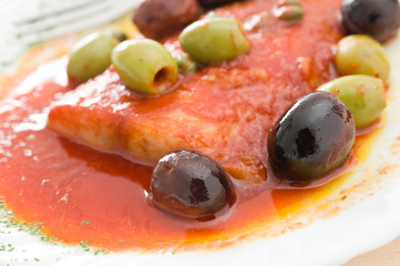 Fish with olives in tomato sauce.