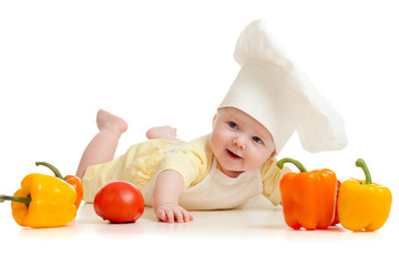 Portrait of a baby wearing a chef hat with healthy  food vegetab