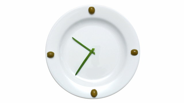 Olives, green onions, a plate - clock on white background
