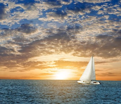 Fototapeta yacht in a sea at the evening