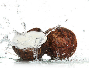 cracked coconut with splashing water - obrazy, fototapety, plakaty