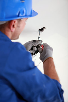 Electrician fixing electrical wiring