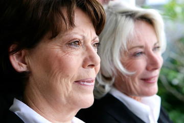 two mature businesswomen posing together