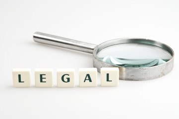 Legal word and magnifying glass