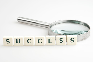 Success word and magnifying glass