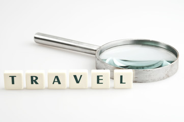 Travel word and magnifying glass