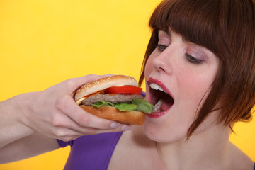 woman eating a hamburger