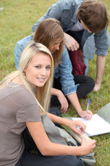 Three students studying in the park