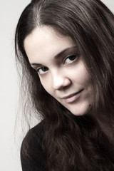 Fototapeta premium Portrait of young smiling woman - processed colors