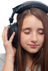 Beautiful teenage girl with closed eyes listens to music