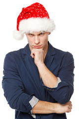 Upset male wearing Santa hat, isolated on white