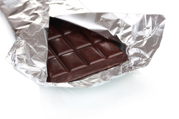 Сhocolate bar in an open silver package isolated on white