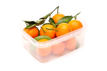Ripe tangerines in plastic container
