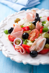 Salad with prosciutto crudo and black olives