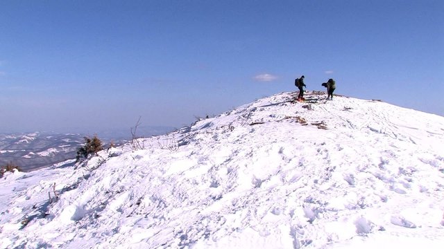 Skiers preparing on top of mountain for skiing