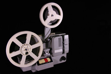Naklejka premium Old projector on a black background