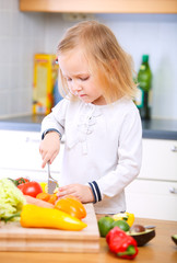 Adorable little girl helping at kitchen