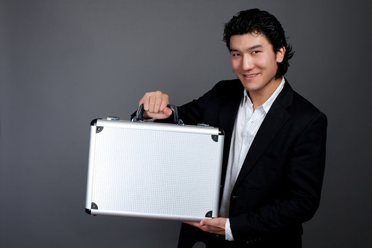 Young asian man holding case