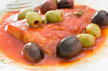 Fish with olives in tomato sauce.