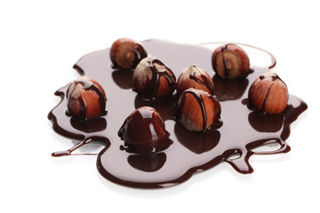delicious hazelnut and chocolate syrup isolated on white