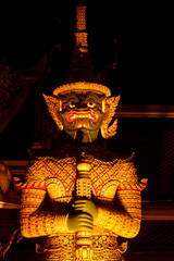 Night scene of statue giant story Ramayana in Thai temple.