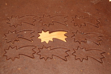 cutting raw dough on Christmas gingerbread
