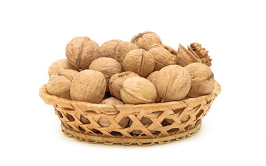 walnuts in a wicker basket on a white background