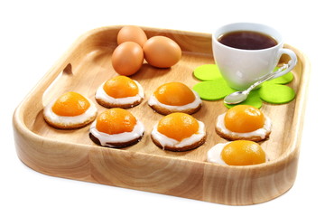 Easter biscuits and a cup of tea on wooden tray.