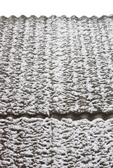 Slate roof covered with thawing snow