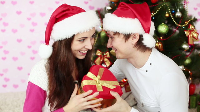 Girl gives her boyfriend a Christmas gift