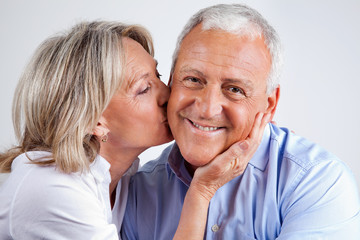 Senior Man Being Kissed By His Wife