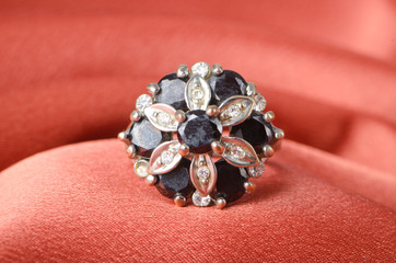 Jewellery ring on the satin background