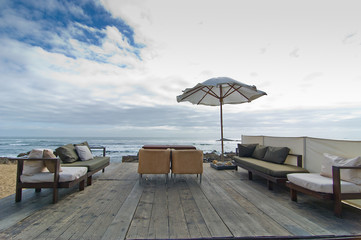 Seafront with sofas on the beach