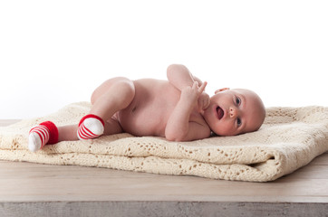 Newborn Baby laying on a white blanket. © pio3