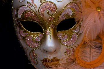 a ornate carnival mask isolated on a black background.
