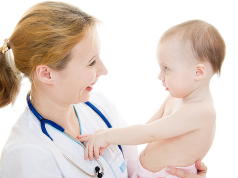 Doctor holding a baby in her arms on a white background.