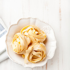 Raw italian pasta in a bowl   (pasta all'uovo- 'egg pasta')