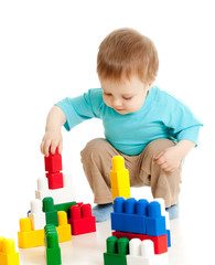 little cheerful child with construction set over white backgroun