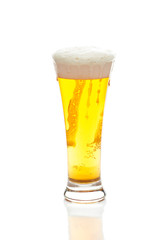 light beer with the foam in a tall glass isolated on white