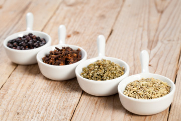 Assorted bowls of spices over wooden table