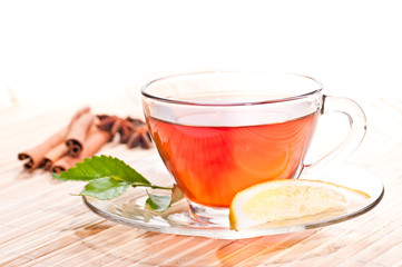 Hot lemon tea in a glass cup close up