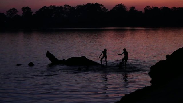 Children playing in the sunset