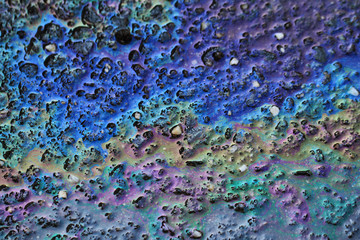 Color gasoline fuel spot on black asphalt