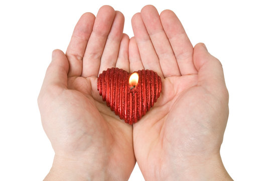 Heart-shape candle in a hands