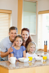 Obraz na płótnie Canvas Family with their breakfast in the kitchen