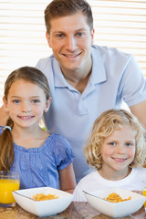 Father with his children and cereals