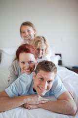 Obraz premium Playful family together on the bed