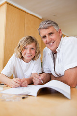 Obraz premium Boy getting help with homework from father