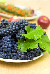 fresh black grape on a background of fruits