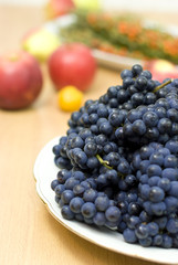 fresh black grape on a background of fruits